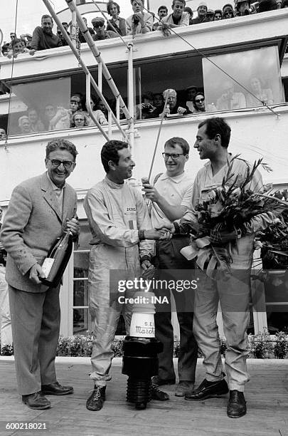 Handshake of Jean Guichet and Nino Vaccarella during their victory in Le Mans 24-hour rally.