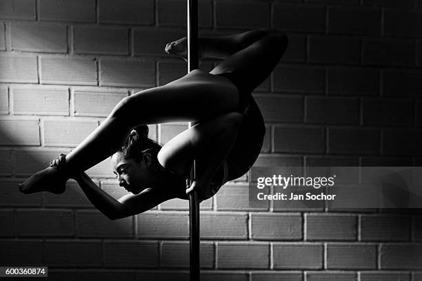 Valeria Aboultaif a young Colombian pole dancer shows off her flexibility skills during a pole dance training session at Academia Pin Up on March 03,...