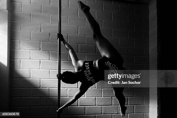 Valeria Aboultaif a young Colombian pole dancer spins around a pole during a pole dance training session at Academia Pin Up on March 03, 2016 in...