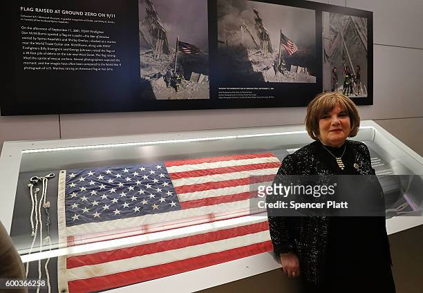 Shirley B. Dreifus stands beside the American flag that was raised by firefighters above the site of the 9/11 attacks on the World Trade Center in...