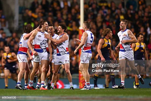 Marcus Bontempelli of the Bulldogs celebrates a goal with team mates during the Second Elimination Final match between the West Coast Eagles and the...