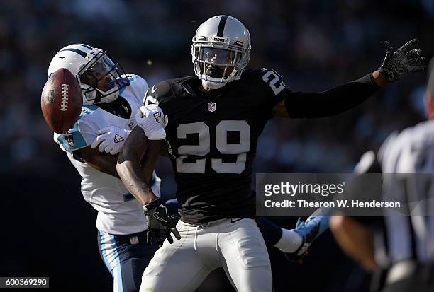 Cornerback David Amerson of the Oakland Raiders breaks up the pass to wide receiver Tajae Sharpe of the Tennessee Titans in the first half of their...