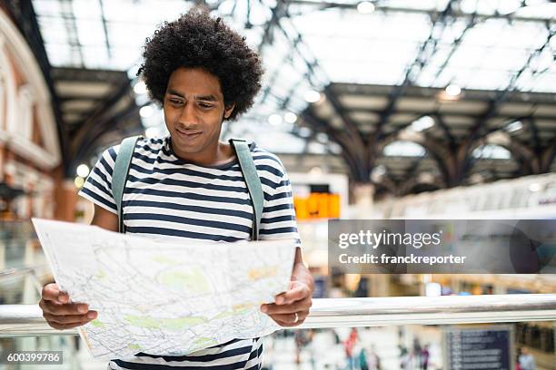 solo traveler in london liverpool street station reading the map - liverpool street railway station stock pictures, royalty-free photos & images
