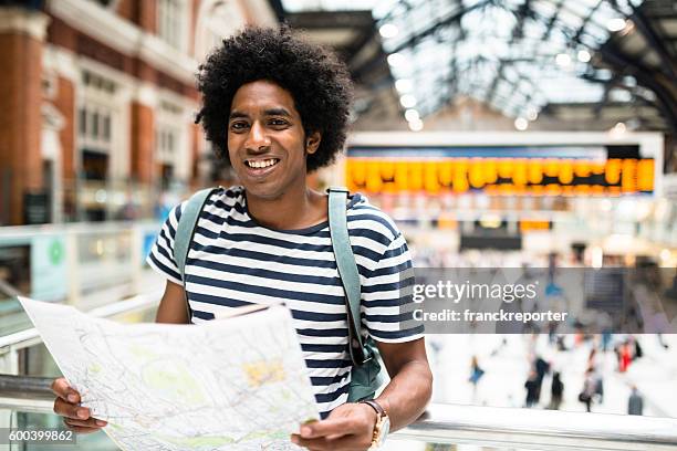 solo traveler in london liverpool street station reading the map - tube map stock pictures, royalty-free photos & images