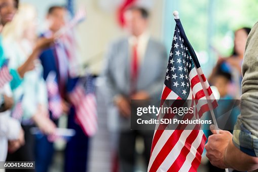 Supporters waving American flags at political campaign rally Supporters waving American flags at political campaign rally