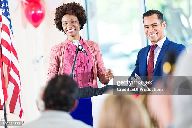 woman smiling while speaking at political rally and supporting candidate - local government official stock pictures, royalty-free photos & images