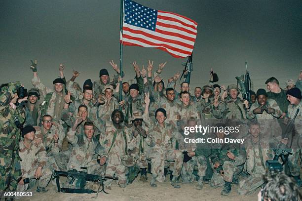 American troops celebrate after taking Kuwait during the Gulf War, 1991.