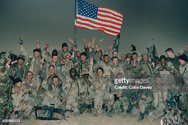 American troops celebrate after taking Kuwait during the Gulf War, 1991.