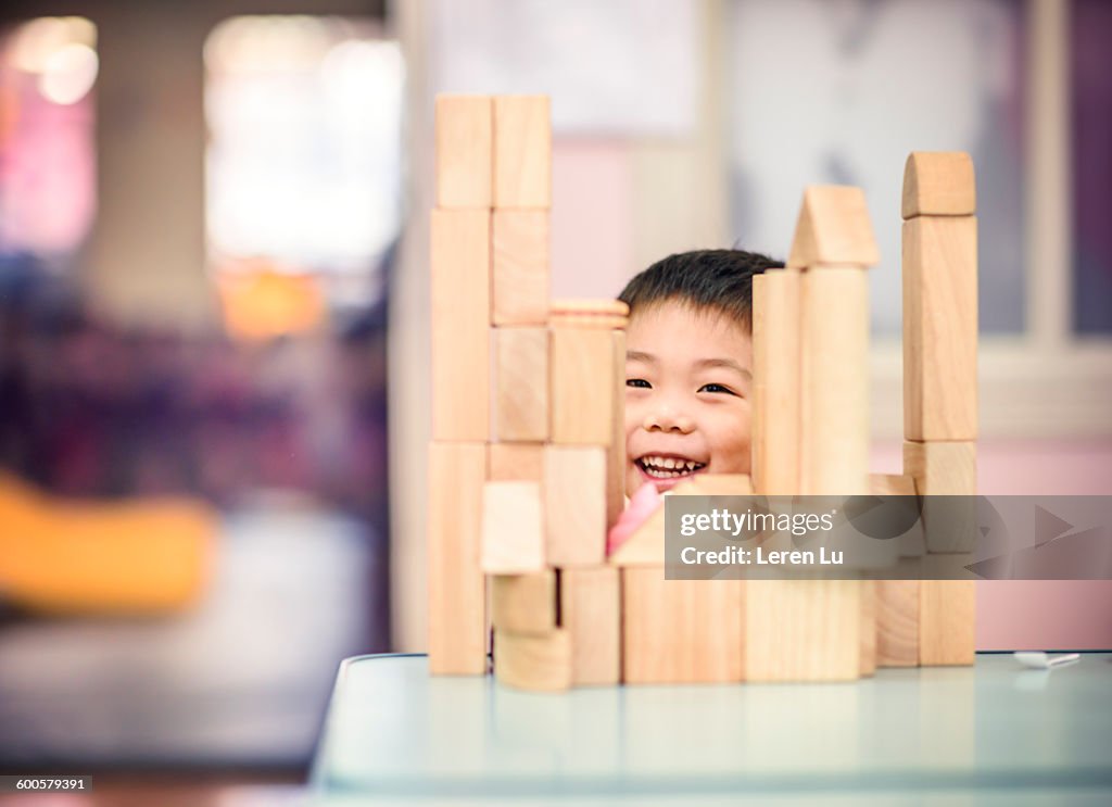 Kid playing toy building blocks