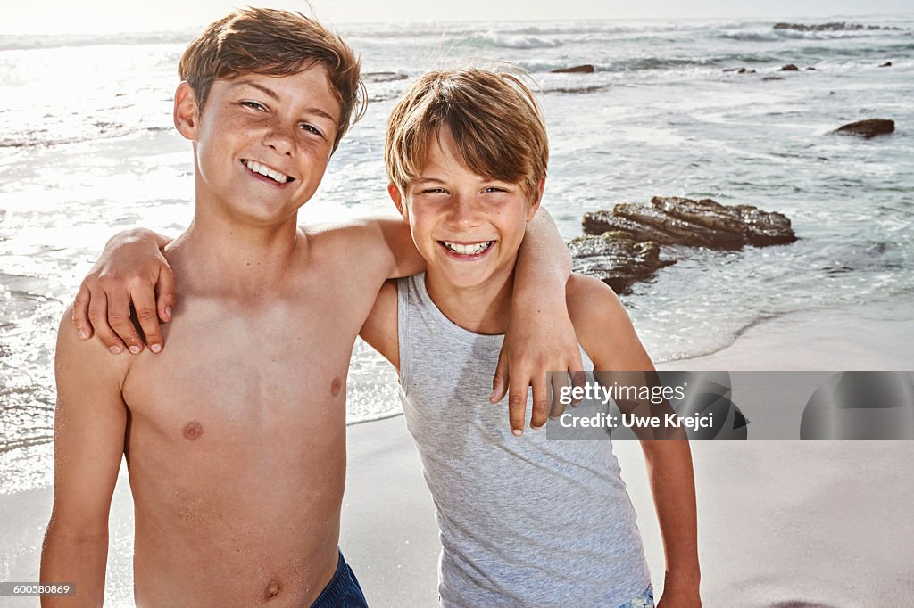 Portrait of two boys (10 - 13 years) on beach