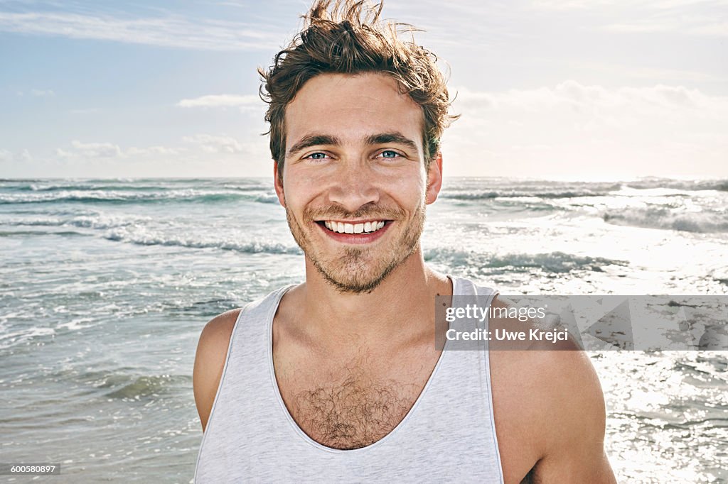 Caucasian man smiling on beach