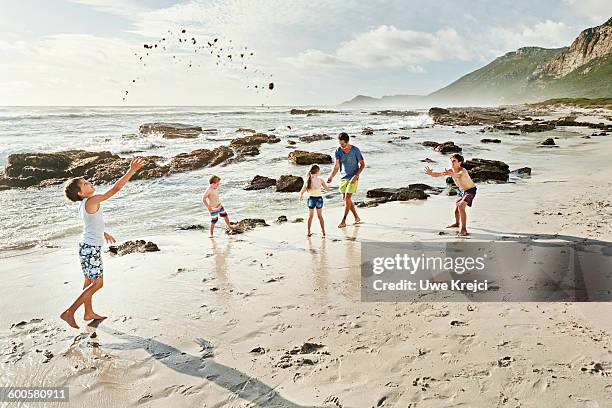 father and kids playing on beach - preteen girl no shirt stock pictures, royalty-free photos & images