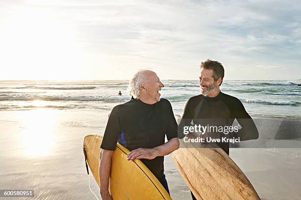 father and his adult son surfing - 2015 80-89 stock pictures, royalty-free photos & images