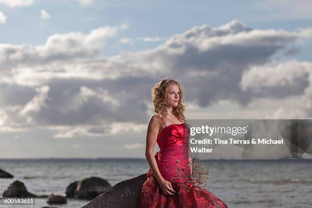 woman standing on the beach. she wears a red dress - tina terras michael walter stock pictures, royalty-free photos & images