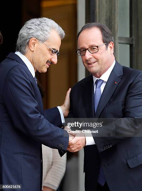 French President Francois Hollande shakes hands with Saudi Prince Alwaleed bin Talal bin Abdulaziz Al Saud after their meeting at the Elysee...