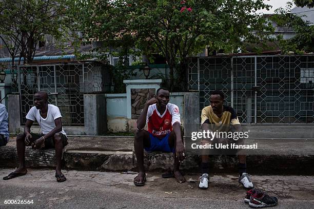 Abdul , a Sudanese asylum seeker sits and takes a rest after playing football in front of the Kolekta hotel, where hundreds of refugees and asylum...