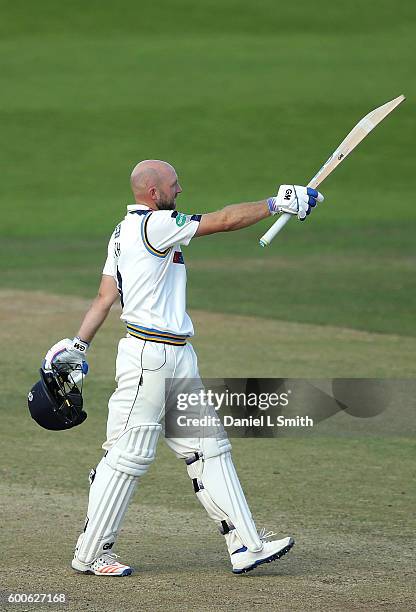 Adam Lythe of Yorkshire salutes the crowd after his century during Day Three of the Specsavers County Championship Division One match between...