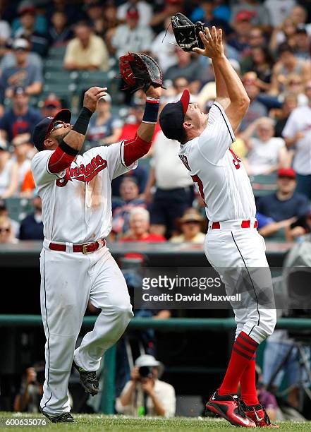 Trevor Bauer and Carlos Santana the Cleveland Indians look to catch pop-up by Jose Altuve of the Houston Astros in the fifth inning at Progressive...