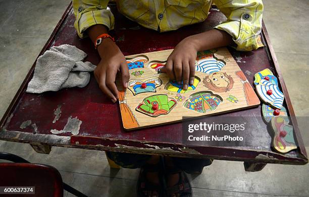 Adarsh , an 8 years old special child , suffering from cerebral palsy , studies as he learns recognizing things by touching in a'Umang' school for...