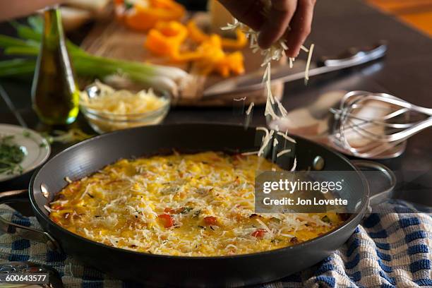 finishing frittata - frittata stock pictures, royalty-free photos & images