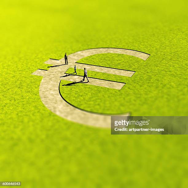 euro sign shaped path in landscape - small group of people foto e immagini stock