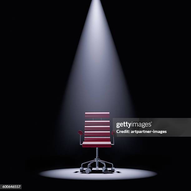 office chair in a spotlight - spotlit fotografías e imágenes de stock