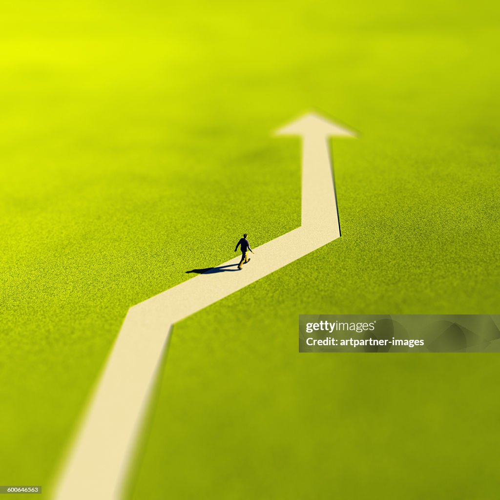 Man walking on an arrow shaped Path