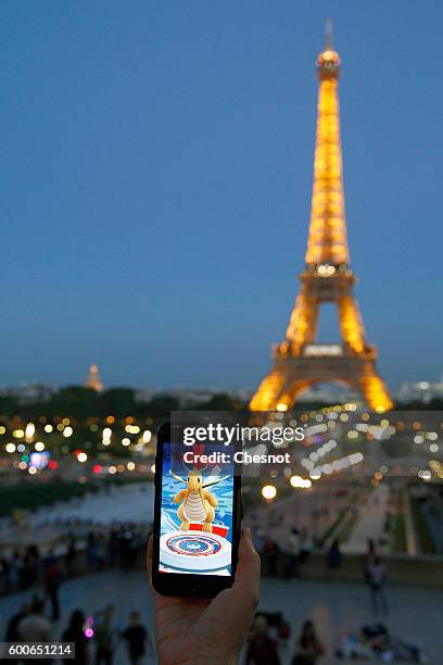 Tourist plays Nintendo Co.'s Pokemon Go augmented-reality game at the Trocadero in front of the Eiffel tower on September 8, 2016 in Paris, France....