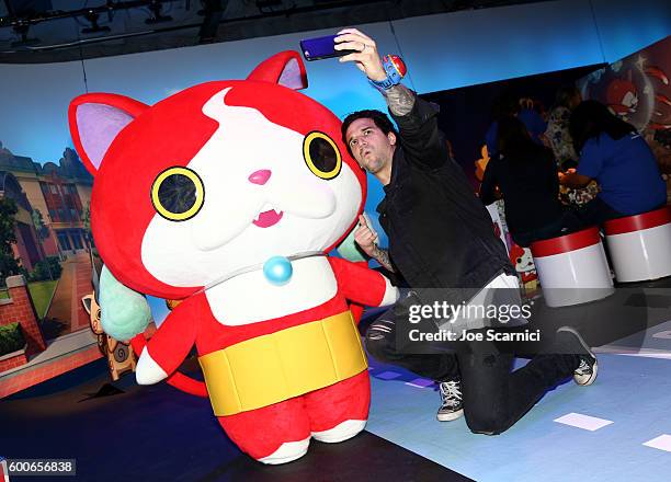 Mark Ballas of ABCs Dancing with the Stars interacts with costume character Jibanyan at the YO-KAI WATCH 2 preview event at Siren Studios on...