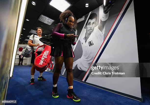 Serena Williams of the United States walks down the player hallway followed by coach Patrick Mouratoglou on her way to the court before playing...