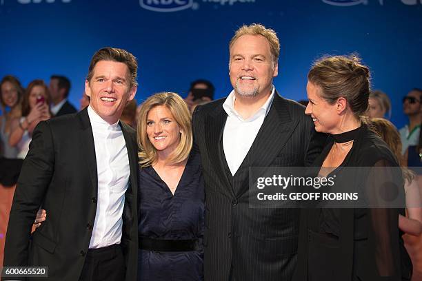 Ethan Hawke and his wife Ryan Shawhughes-Hawke Vincent D'Onofrio and his wife Carin van der Donk pose for photographers at the premiere of the...