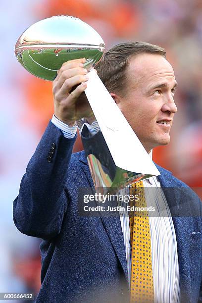 Peyton Manning holds the Lombardi Trophy to celebrate the Denver Broncos in win Super Bowl 50 at Sports Authority Field at Mile High before taking on...