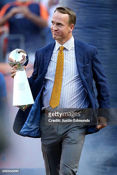 Peyton Manning holds the Lombardi Trophy to celebrate the Denver Broncos in win Super Bowl 50 at Sports Authority Field at Mile High before taking on...