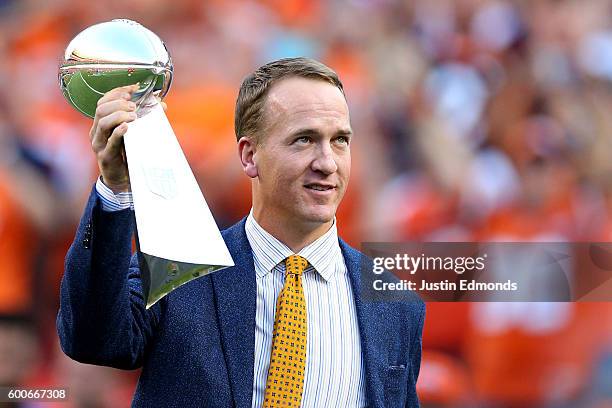 Peyton Manning holds the Lombardi Trophy to celebrate the Denver Broncos in win Super Bowl 50 at Sports Authority Field at Mile High before taking on...