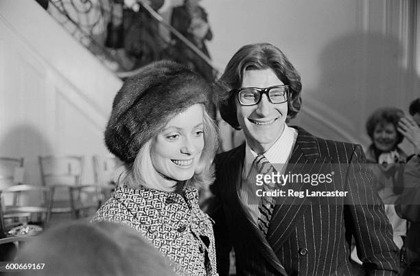 French fashion designer Yves Saint Laurent and French actress Catherine Deneuve at a party and fashion show held by Saint Laurent in Paris, France,...
