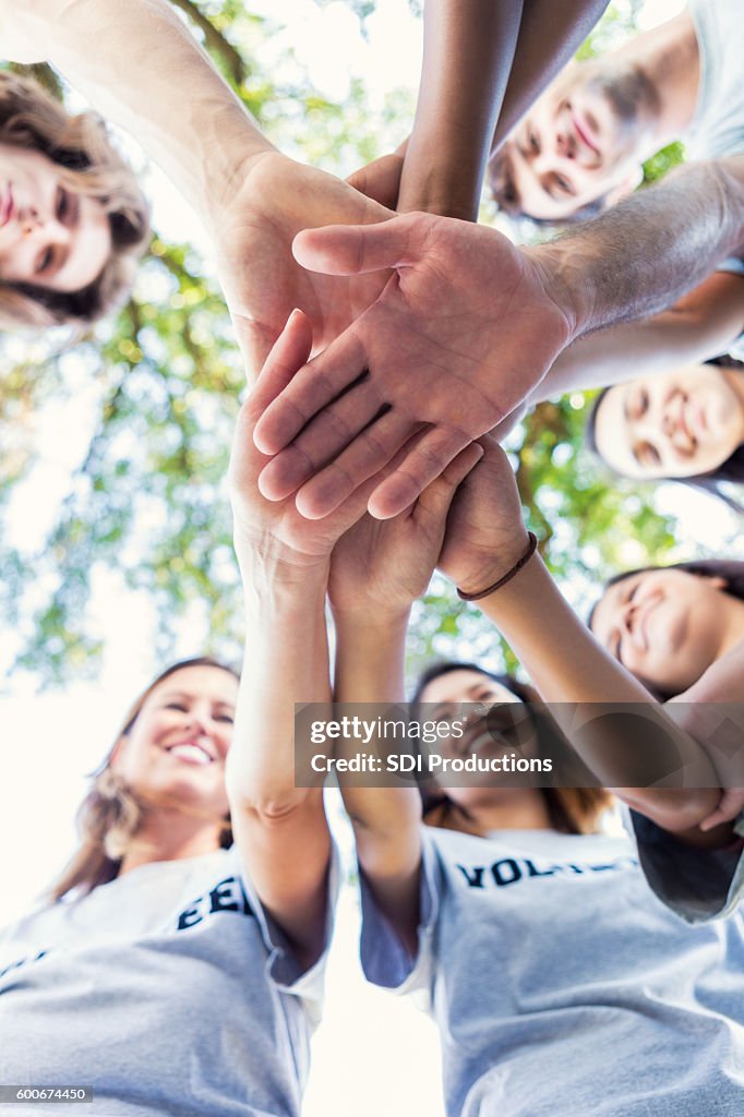 Diverse group of adults outdoors in a huddle