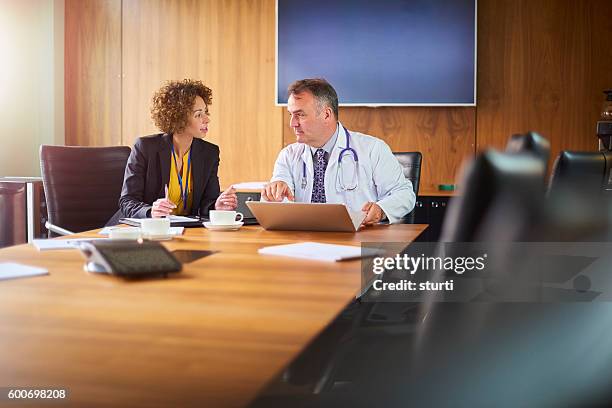 senior doctor with administrator - hr suit stockfoto's en -beelden