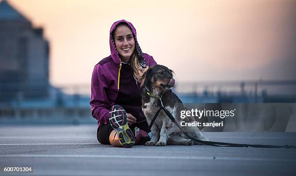 portrait of a young athlete with her canine friend - 訓練犬 個照片及圖片檔