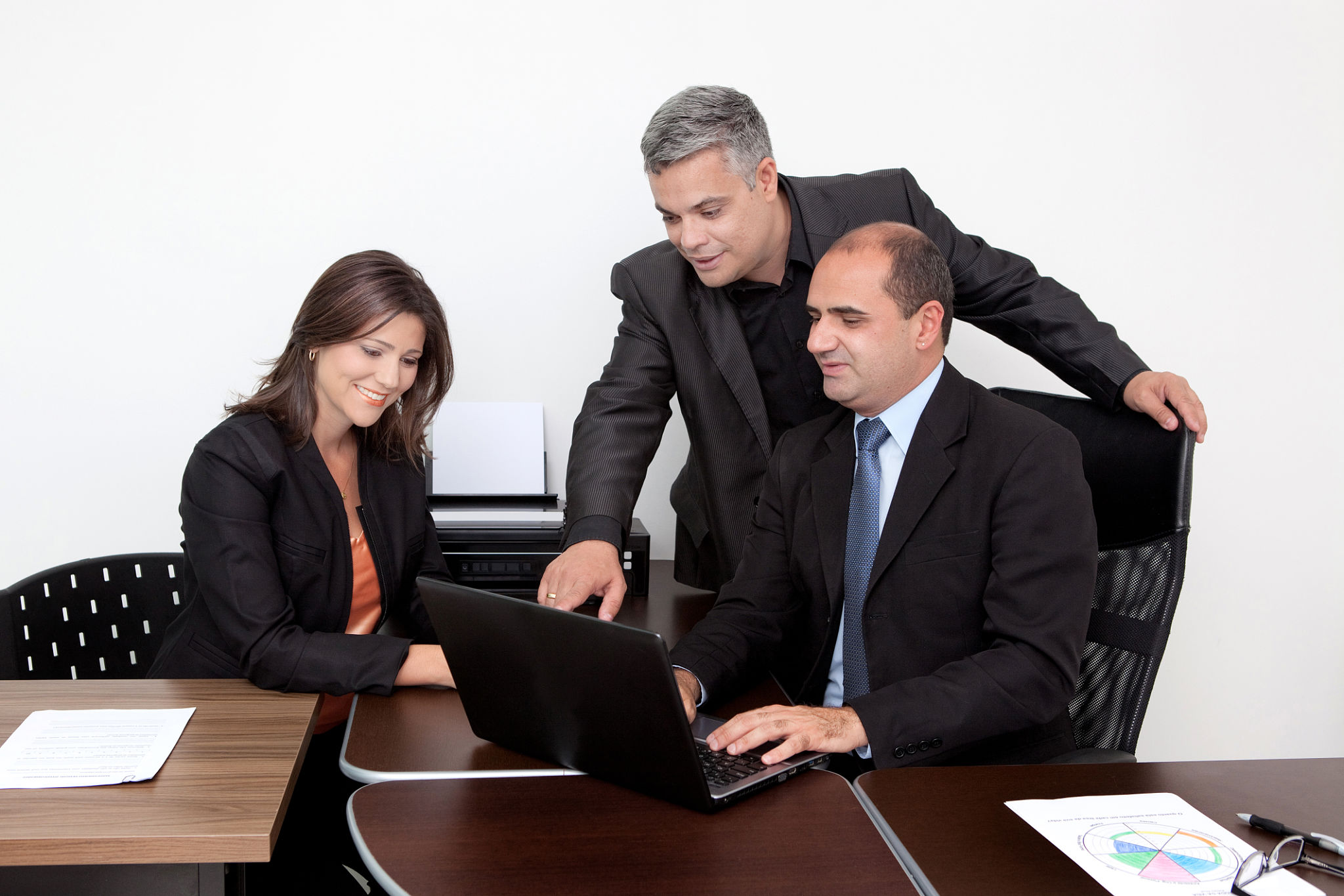 Latin Business Coach Giving Instructions Pointing at Laptop at Office Latin Business Coach Giving Instructions Pointing at Laptop at Office
