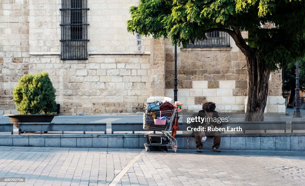 Homeless with his cart at the street