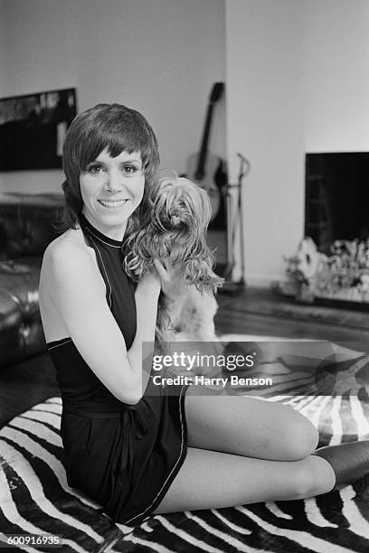 English actress Judy Carne with a small dog, UK, 15th March 1970.