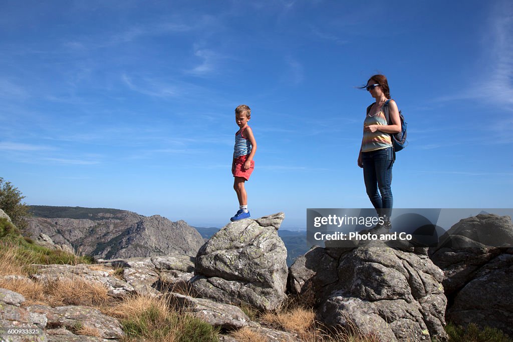 Woman with her child on top of a mountain