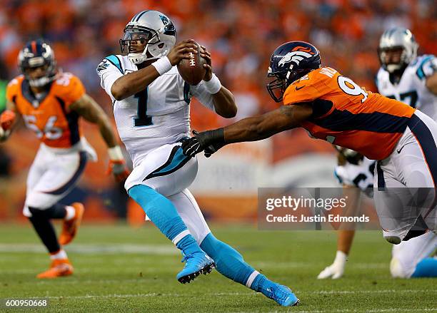 Quarterback Cam Newton of the Carolina Panthers tries to avoid a tackle from nose tackle Sylvester Williams of the Denver Broncos in the first half...