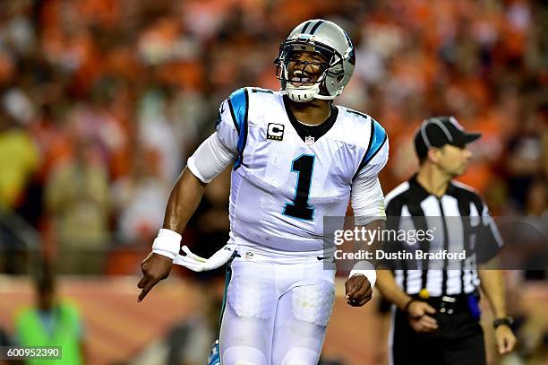 Quarterback Cam Newton of the Carolina Panthers celebrates after scoring on a two-yard rushing touchdown in the second quarter against the Denver...