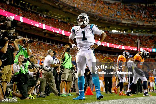 Quarterback Cam Newton of the Carolina Panthers celebrates after scoring on a two-yard rushing touchdown in the second quarter against the Denver...