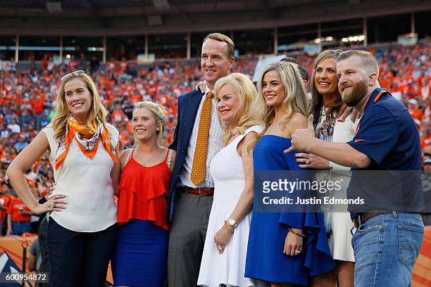 Peyton Manning poses with Annabel Bowlen and other members of the Bowlen family before the Denver Broncos take on the Carolina Panthers at Sports...