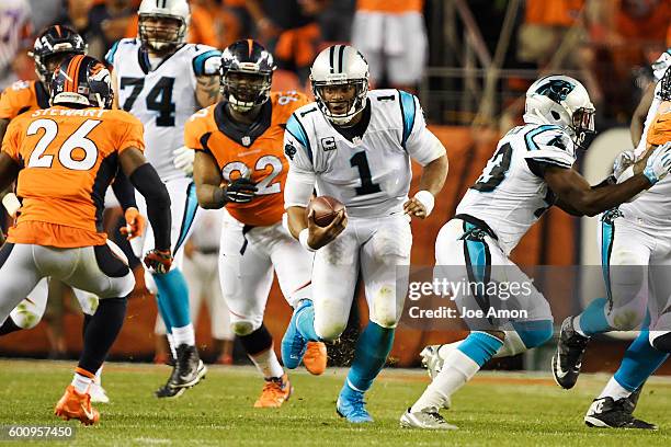 Quarterback Cam Newton of the Carolina Panthers takes off running as free safety Darian Stewart of the Denver Broncos lines him up during the second...