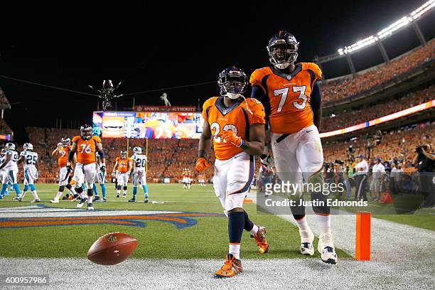 Running back C.J. Anderson of the Denver Broncos celebrates with offensive tackle Russell Okung after Anderson scores on a 25-yard reception in the...