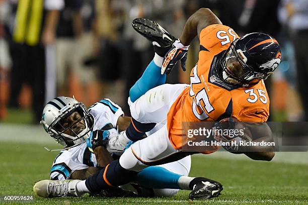 Defensive back Robert McClain of the Carolina Panthers tackles running back Kapri Bibbs of the Denver Broncos during the third quarter. The Denver...