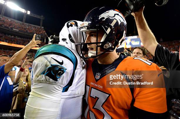 Quarterback Cam Newton of the Carolina Panthers shakes hands with quarterback Trevor Siemian of the Denver Broncos after the Panthers lose to the...
